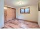 Bedroom featuring hardwood floors, neutral paint, closet, and natural light for a comfortable retreat at 21191 Pleasant Park Rd, Conifer, CO 80433