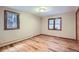 Well-lit bedroom showcasing hardwood floors, windows, and neutral paint perfect for relaxation at 21191 Pleasant Park Rd, Conifer, CO 80433
