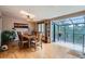 Dining room with hardwood floors, a skylight, and a sunroom that looks out to the trees at 21191 Pleasant Park Rd, Conifer, CO 80433
