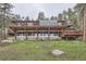 Multi-level home with spacious decks and stunning views, set on a lush, grassy lot at 21191 Pleasant Park Rd, Conifer, CO 80433