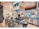 Well-equipped kitchen featuring a center island with cooktop and bar seating at 21191 Pleasant Park Rd, Conifer, CO 80433