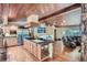 Large kitchen island with granite countertop, seating, and hardwood floors at 21191 Pleasant Park Rd, Conifer, CO 80433