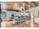 Spacious kitchen with wooden ceiling, large island, and stainless steel appliances at 21191 Pleasant Park Rd, Conifer, CO 80433