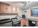 Laundry room features stainless steel appliances, sink, cabinets, and a mini-fridge for ultimate convenience at 21191 Pleasant Park Rd, Conifer, CO 80433