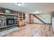 Living room features a stone fireplace, built-in shelves, and hardwood floors that add warmth and character at 21191 Pleasant Park Rd, Conifer, CO 80433