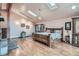 Main bedroom with hardwood floors, skylights, and an alcove that opens to an outdoor deck at 21191 Pleasant Park Rd, Conifer, CO 80433