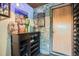 Wine cellar features a cabinet, wine rack, and stone wall, perfect for wine storage and display at 21191 Pleasant Park Rd, Conifer, CO 80433