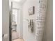 Bathroom doorway revealing sink, vanity and shower behind hanging towel at 9222 E Arbor Cir # L, Englewood, CO 80111