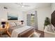 Bright bedroom featuring a ceiling fan, a sliding glass door to the outside, and neutral decor at 9222 E Arbor Cir # L, Englewood, CO 80111