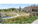 Manicured community grounds with walking paths and a serene pond view at 9222 E Arbor Cir # L, Englewood, CO 80111