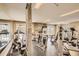 Well-equipped gym with various machines, mirrors, and natural light at 9222 E Arbor Cir # L, Englewood, CO 80111