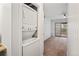 A stacked washer and dryer conveniently positioned near living area with glass patio doors at 9222 E Arbor Cir # L, Englewood, CO 80111