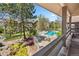 Community pool with ample lounge seating and lush landscaping viewed from a balcony at 9222 E Arbor Cir # L, Englewood, CO 80111