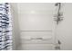 A simple shower area with a shower head and a tie-dye shower curtain in a functional space at 9222 E Arbor Cir # L, Englewood, CO 80111