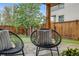 Backyard patio area with comfortable seating, putting green and modern privacy fence at 2090 Irving St, Denver, CO 80211