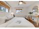 Inviting bedroom with wood floors, ceiling fan, and two windows with natural light at 2090 Irving St, Denver, CO 80211