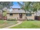 Charming two-story brick home with manicured lawn and mature trees at 2090 Irving St, Denver, CO 80211