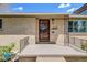 Close-up of the front porch with brickwork, decorative iron railings, and the house number displayed at 2090 Irving St, Denver, CO 80211