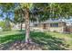 Charming home featuring a lush front yard with mature trees and a inviting front porch at 2090 Irving St, Denver, CO 80211