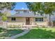 Charming brick home featuring a well-manicured lawn and landscaped garden, exuding curb appeal at 2090 Irving St, Denver, CO 80211