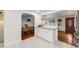 Bright kitchen with white cabinetry, tile flooring, and an open view to the dining area at 2090 Irving St, Denver, CO 80211