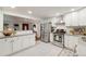 Bright kitchen features white cabinetry, stainless steel appliances, and modern tile flooring at 2090 Irving St, Denver, CO 80211