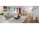 Open-concept living room with hardwood floors, stylish furnishings, and seamless flow to the kitchen at 2090 Irving St, Denver, CO 80211