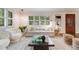 Bright and stylish living room with large windows, plantation shutters, and modern decor at 2090 Irving St, Denver, CO 80211