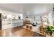 Spacious open-concept living room with hardwood floors, comfortable seating, and a view into the kitchen at 2090 Irving St, Denver, CO 80211