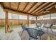 Covered patio area in the backyard with seating and an artificial putting green at 2090 Irving St, Denver, CO 80211