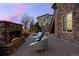 Outdoor stone patio with a fireplace, outdoor seating, and stairs to the upper level at 10795 Sundial Rim Rd, Highlands Ranch, CO 80126