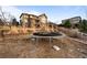 Landscaped backyard with trampoline and retaining wall provides outdoor enjoyment and a place for fun activities at 10795 Sundial Rim Rd, Highlands Ranch, CO 80126