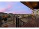 View of the neighborhood from the wood balcony with black metal railings and stone pillars at 10795 Sundial Rim Rd, Highlands Ranch, CO 80126