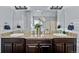 Bathroom showcasing dual sinks, granite countertops, and a large mirror with modern lighting fixtures at 10795 Sundial Rim Rd, Highlands Ranch, CO 80126