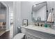 Stylish powder room with marble countertop, modern fixtures, and elegant mirror at 10795 Sundial Rim Rd, Highlands Ranch, CO 80126