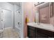 Bright bathroom featuring tile floors, a shower over tub, a modern vanity, and fresh paint at 10795 Sundial Rim Rd, Highlands Ranch, CO 80126