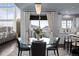 Bright dining area with a chandelier, balcony access, and seamless flow to kitchen at 10795 Sundial Rim Rd, Highlands Ranch, CO 80126