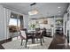 Open-concept dining with modern lighting and access to balcony, adjacent to the kitchen at 10795 Sundial Rim Rd, Highlands Ranch, CO 80126