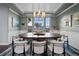 Dining room with a large table and stylish chairs beneath an elegant chandelier at 10795 Sundial Rim Rd, Highlands Ranch, CO 80126