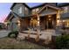 Inviting front porch with stone pillars and seating, offering a relaxing outdoor space at 10795 Sundial Rim Rd, Highlands Ranch, CO 80126