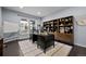 Bright home office with large desk, shelving, and natural light, creating an ideal workspace at 10795 Sundial Rim Rd, Highlands Ranch, CO 80126