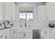 Modern kitchen with white cabinets, stainless steel appliances, and quartz countertops at 10795 Sundial Rim Rd, Highlands Ranch, CO 80126