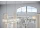 Bright living area featuring a modern light fixture and a large arched window with scenic views at 10795 Sundial Rim Rd, Highlands Ranch, CO 80126
