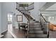 Elegant staircase featuring dark wood steps, banister, and white risers at 10795 Sundial Rim Rd, Highlands Ranch, CO 80126