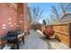 Side yard with stone pavers, BBQ, grill and mature landscaping providing a private outdoor space at 1430 S Lima St, Aurora, CO 80012