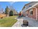 Beautiful backyard with a patio area, lush lawn, mature trees, ideal for outdoor entertaining at 1430 S Lima St, Aurora, CO 80012