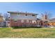 The backyard features a lush lawn, a shed, a patio area, mature trees, and a red brick exterior at 1430 S Lima St, Aurora, CO 80012