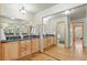 Spacious bathroom with dual sinks, granite counters, wood cabinets, and mirrored closet doors at 1430 S Lima St, Aurora, CO 80012