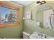 Bathroom features vanity sink, toilet, and window for natural light at 1430 S Lima St, Aurora, CO 80012