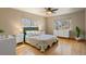Bright bedroom with hardwood floors, a ceiling fan, and large windows providing ample natural light at 1430 S Lima St, Aurora, CO 80012
